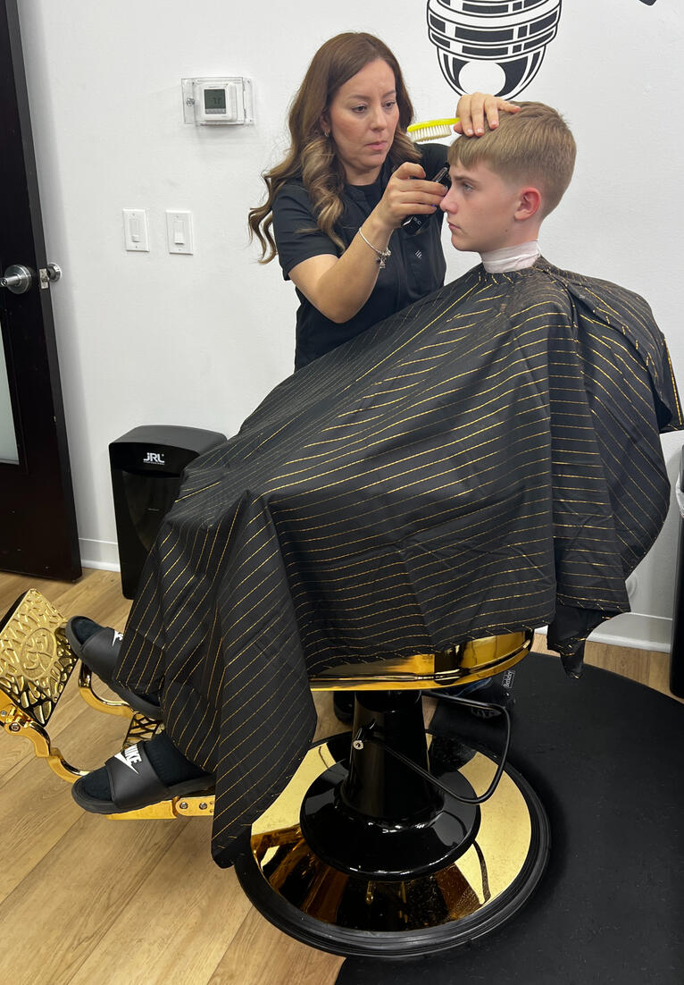 Barber cutting kid's hair